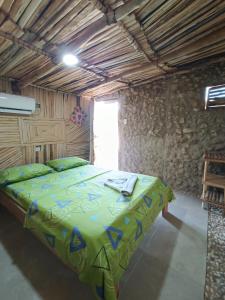a bedroom with a large bed in a stone wall at Del Mar Vendra in Manaure Viejo