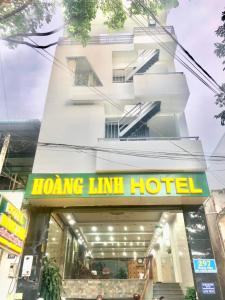 a hotel with a sign in front of a building at Hoàng Linh Hotel in Buon Ma Thuot