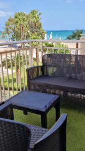 a patio with chairs and tables and the beach at Perfect direct beach access in Benicàssim
