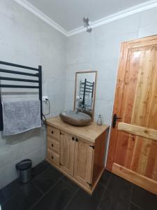 baño con lavabo y espejo en la encimera en Casa con quincho y piscina privados en Recinto