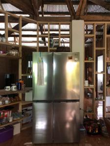 a large stainless steel refrigerator in a kitchen at Sheila’s Villa in Leyte