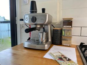 a coffee maker sitting on top of a table at Tiny House Clunes at The Old Butter Factory in Clunes