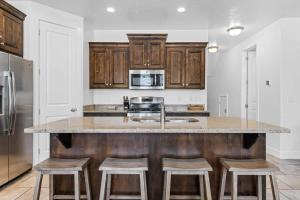 a kitchen with wooden cabinets and a counter with stools at Narrow's Gateway townhouse in Washington
