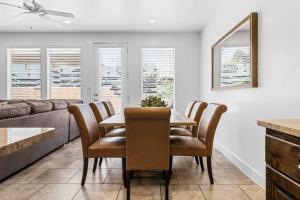 a dining room with a table and chairs and a couch at Narrow's Gateway townhouse in Washington