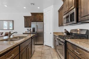 a kitchen with wooden cabinets and a stainless steel refrigerator at Narrow's Gateway townhouse in Washington