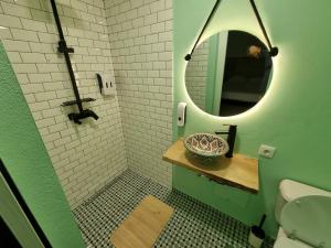 a bathroom with a mirror and a sink and a toilet at Wonder Charm Guesthouse in Albufeira