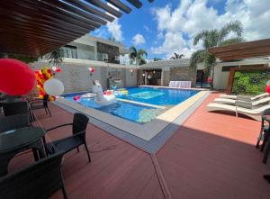 a swimming pool in the middle of a house at Rustic Crown Hotel in Alaminos