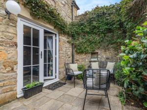a patio with two chairs and a table at Raven Cottage in Barnard Castle