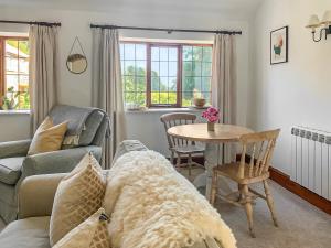 a living room with a couch and a table at Corn Stook - 16867 in Sawdon