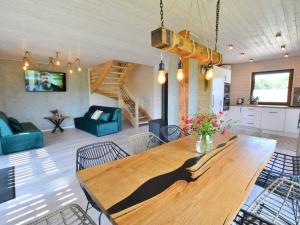 a living room with a wooden table and chairs at Comfortable holiday home, sauna hot tub included in Sulechowo