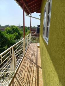 a porch of a green building with a window at Sevelle Meadows 2 Extended Stay in Spanish Town