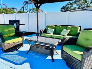 a patio with two chairs and a table and a couch at Busch Gardens Deluxe Edition w/heatedpool in Tampa