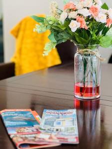 a vase of flowers sitting on a table with magazines at Busch Gardens Deluxe Edition w/heatedpool in Tampa