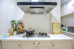 a kitchen with a stove with a bowl on it at Gala Seeker INN in Hangzhou