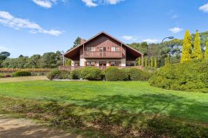 a large house with a green lawn in front of it at Northway Downs Estate Vineyard in Balnarring