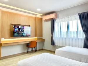 a hotel room with two beds and a flat screen tv at Air Diamond Hotel in Ban Nong Khong