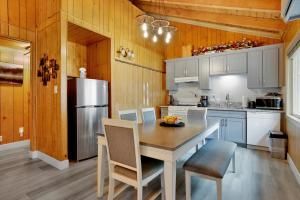 a kitchen with a table with chairs and a refrigerator at Sweet Retreat 1- Cozy Relaxing Resort Cabin in Big Bear Lake