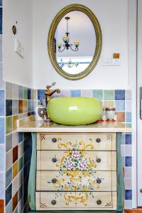 a bathroom with a sink and a mirror on a dresser at Gala Seeker INN in Hangzhou