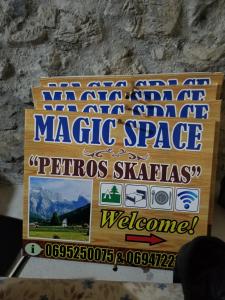 a sign for a magic space in a stone wall at Magic Space Petros Skafias in Shkodër