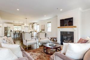 a living room with white furniture and a fireplace at In the Heart of the City in Marietta