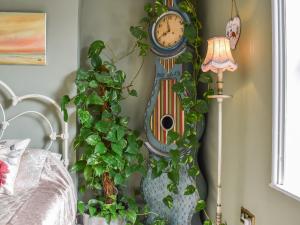 a clock hanging on a wall next to a bed at The Epple Bay Retreat in Birchington