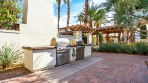 a outdoor kitchen with a grill in a backyard at LV204 Airy Upstairs 2 Bedroom w Private Balcony in La Quinta