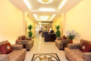 a lobby with couches and a person in the background at Rising Dragon Hotel in Hanoi