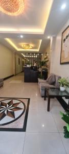 a living room with a couch and a table at Rising Dragon Hotel in Hanoi
