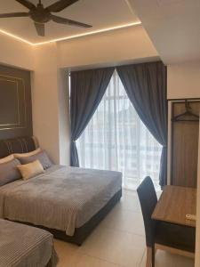 a bedroom with a bed with a ceiling fan and a window at My Cozy 2-bedroom Apartment in Melaka