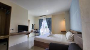 a hotel room with a bed and a window at 98 Tower Chiang Mai in Chiang Mai