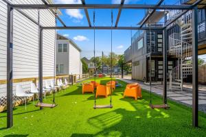 a group of chairs on the grass in a building at Orange Container @EADO Juice Box in Houston
