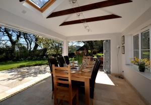 a dining room with a wooden table and chairs at Culverwells in Axminster