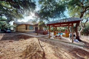 a house with a playground with a pavilion in a yard at Captivating Cottage in New Braunfels