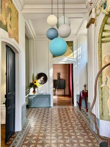 a hallway with blue and white walls and a ceiling at Le Henri IV in Le Mans