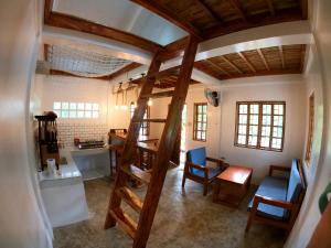 a living room with a spiral staircase in a house at L'Astrolabe - Tiny House in Baras