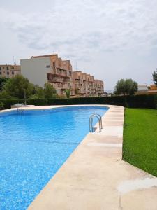 a swimming pool with blue water in a building at Apartamento en Calpe in Calpe