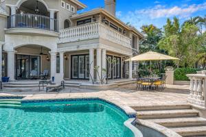 a house with a swimming pool in front of a house at Mediterranean Villa Heated Pool Venice of America Riverside View Venetian Key RESlDENCES in Fort Lauderdale