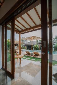 an external view of a house with a patio at EHOA BALI Nyanyi Boutique Hotel - In front of entrance to NUANU in Tanah Lot