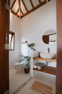 a bathroom with a sink and a bath tub at EHOA BALI Nyanyi Boutique Hotel - In front of entrance to NUANU in Tanah Lot