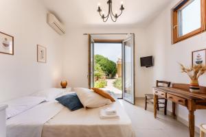 a bedroom with two beds and a desk and a window at Villa Mazzella in Procida