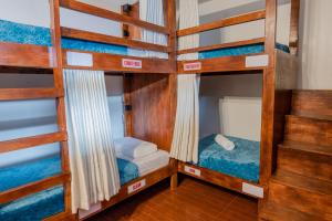 a room with four bunk beds in a house at Public House Hostel in Pusok