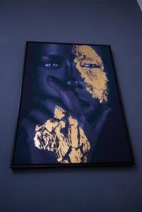 a framed picture of a woman on a wall at Appartement meublé in Douala