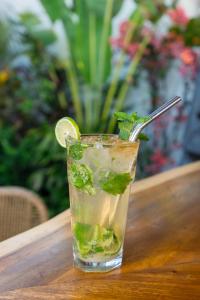 a drink with a spoon in a glass on a table at EHOA BALI Nyanyi Boutique Hotel - In front of entrance to NUANU in Tanah Lot