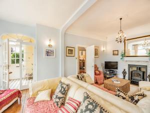 a living room with a couch and a fireplace at The Cottage in St Margarets at Cliff