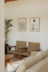 a living room with two chairs and a couch at Sage Villas Bingin in Uluwatu