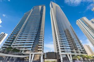 two tall buildings in a city with a blue sky at Circle on Cavill Contemporary Luxury and Spacious Three Bedroom Apartment in Gold Coast