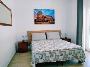 a bedroom with a bed and a picture on the wall at un passo dal mare in Fiumicino
