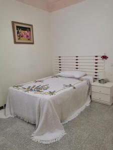 een slaapkamer met een bed met een witte deken erop bij Casa di Tony in Montegiorgio