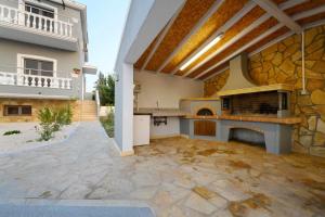 a large outdoor kitchen with a stone wall at Villa Alina in Lefkimmi