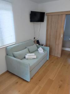 a couch in a living room with two towels on it at Veranda in Saborsko
